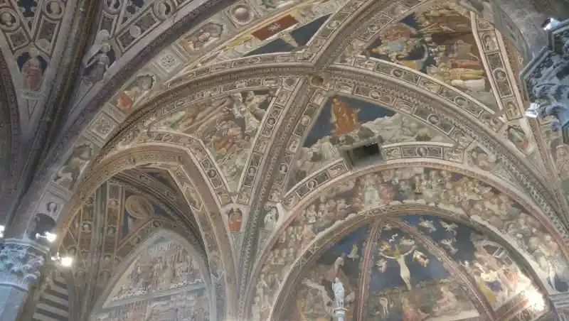 Light at the center of a cross on the ceiling of Siena Cathedral